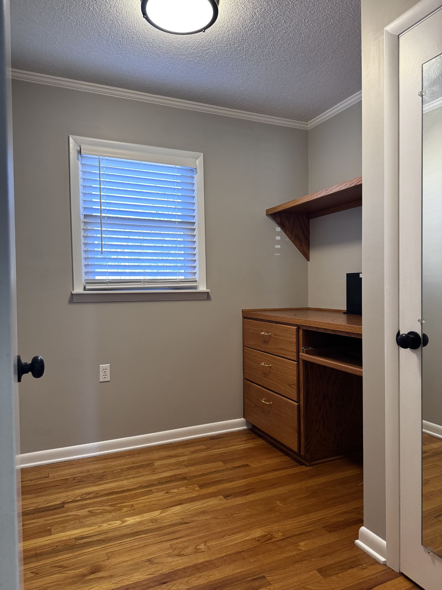 211 Church Street Loretto, TN 38469 - Photo 20 of 37 a view of an empty room with wooden floor and a window