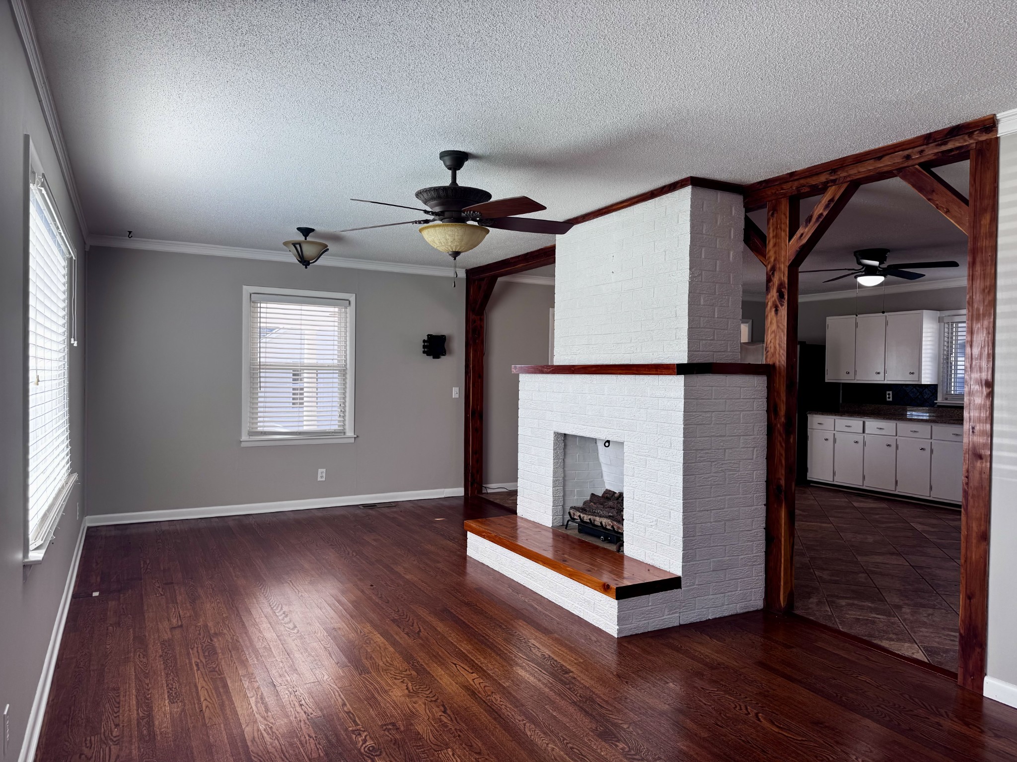 211 Church Street Loretto, TN 38469 - Photo 7 of 37 a view of a livingroom with wooden floor and a fireplace