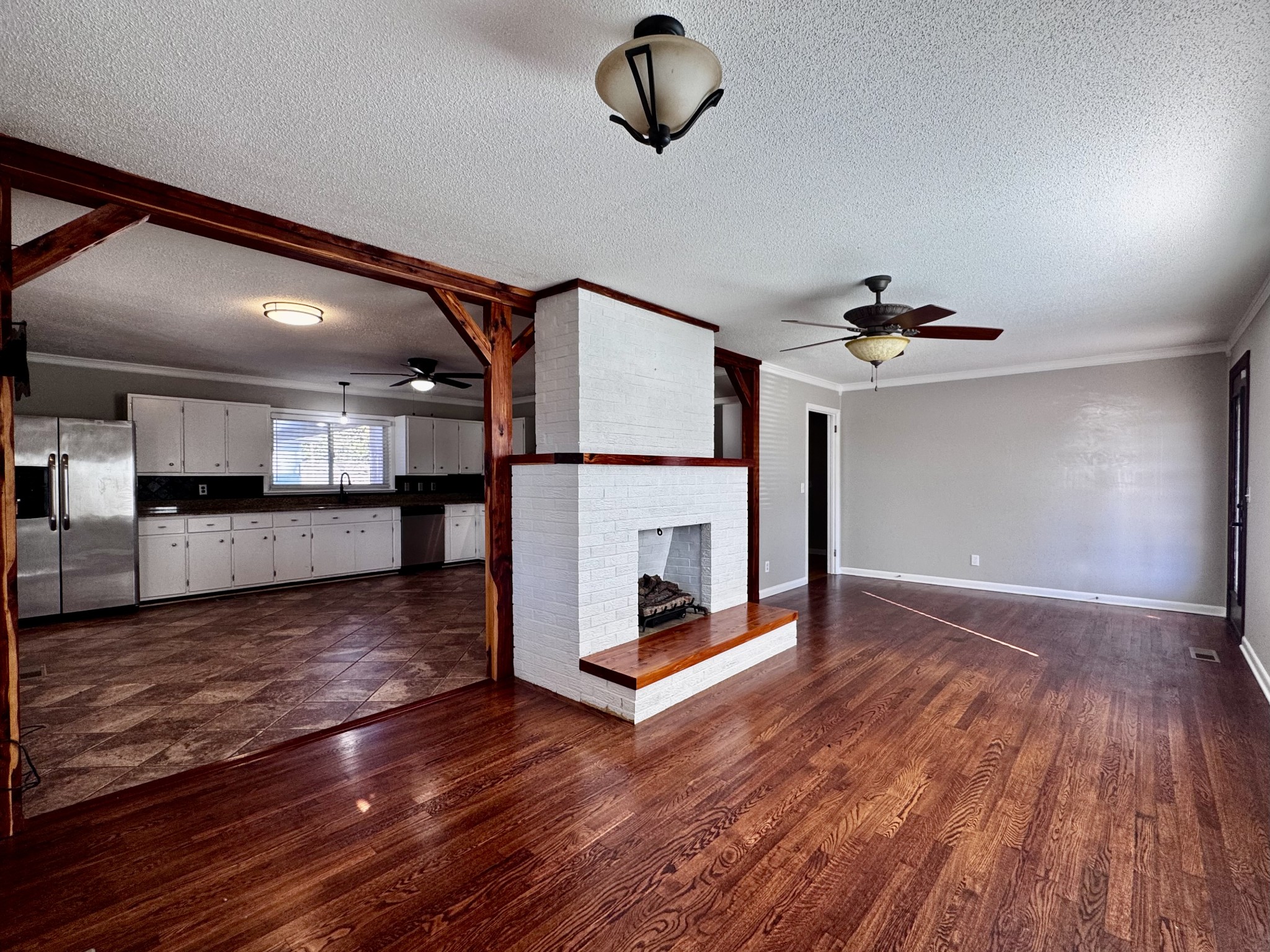 211 Church Street Loretto, TN 38469 - Photo 8 of 37 a view of a livingroom with wooden floor and a ceiling fan