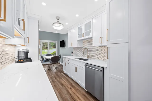 a kitchen with a sink appliances and cabinets