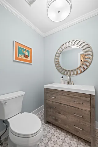 a bathroom with a toilet a sink and mirror
