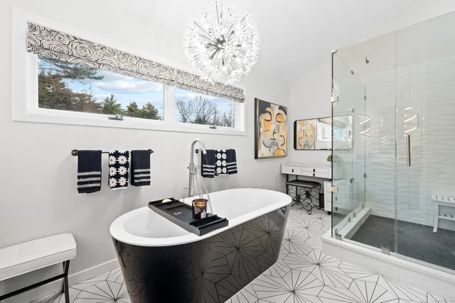 a living room with furniture a table and kitchen view