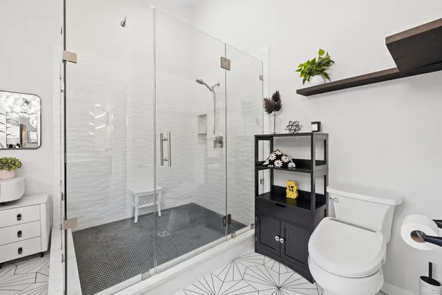 a bathroom with a toilet a sink and shower