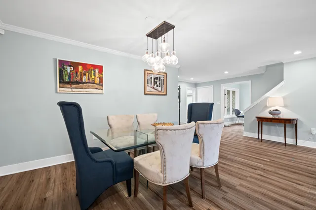 a view of a dining room with furniture and wooden floor