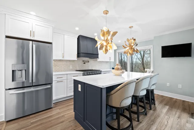 a kitchen with stainless steel appliances a stove a sink and a refrigerator