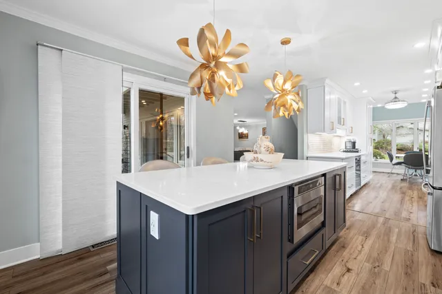a kitchen with a sink and a wooden floor