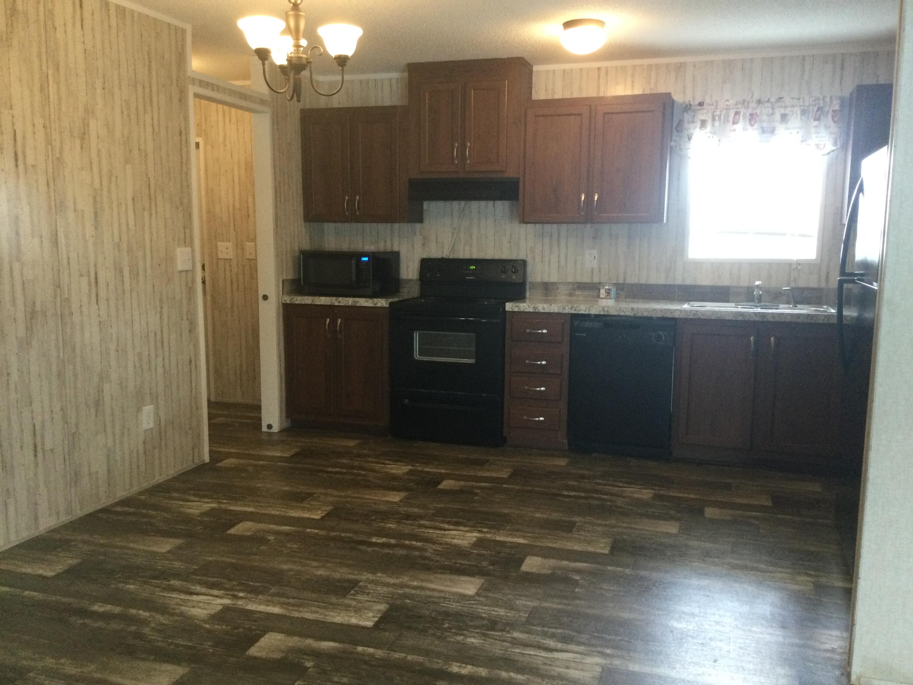 5000 Southeast Federal Highway, Unit 82 Stuart, FL 34997 - Photo 7 of 14 a kitchen with a refrigerator and window
