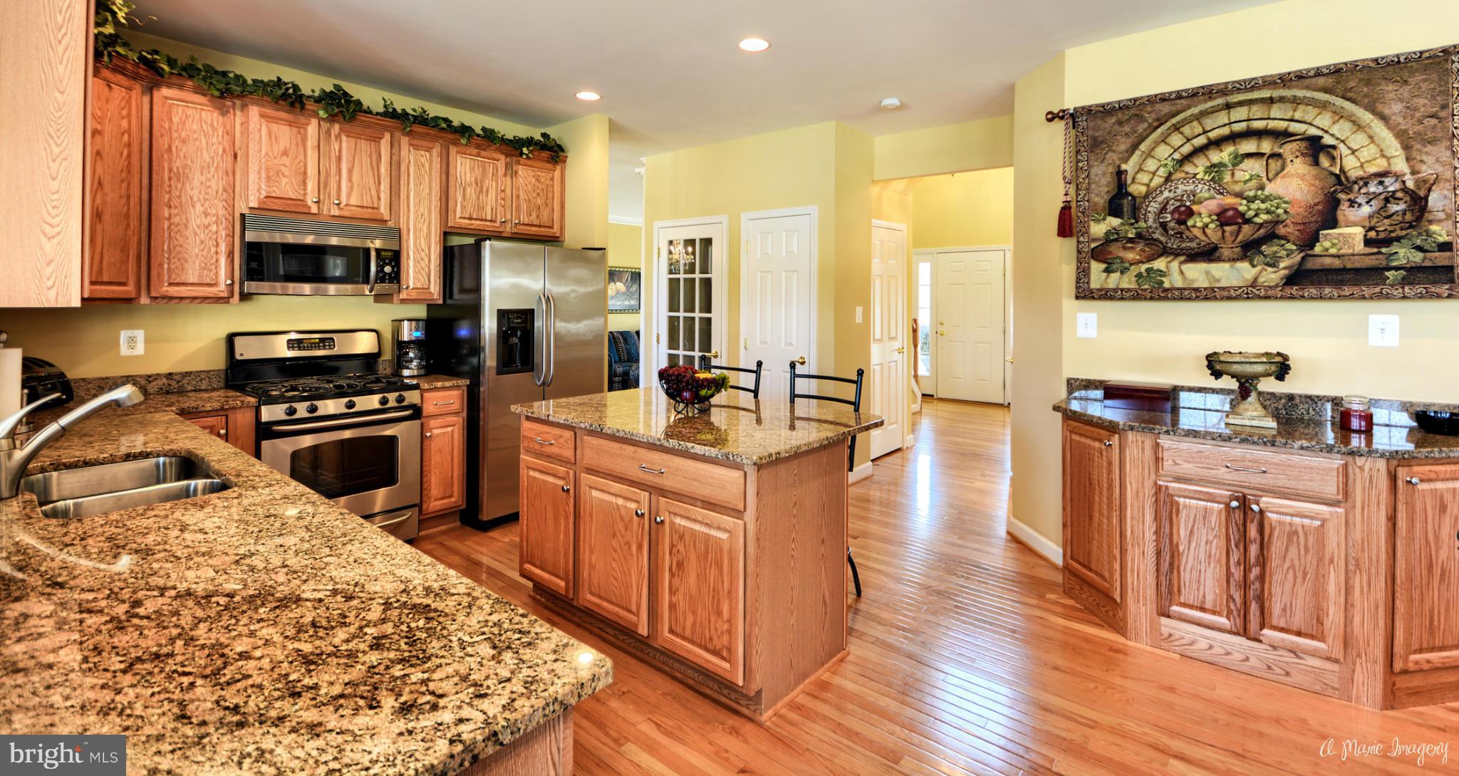 1719 Canal Clipper Court Point of Rocks, MD 21777 - Photo 3 of 30 a kitchen with stainless steel appliances granite countertop a stove top oven a refrigerator a sink and dishwasher with wooden floor