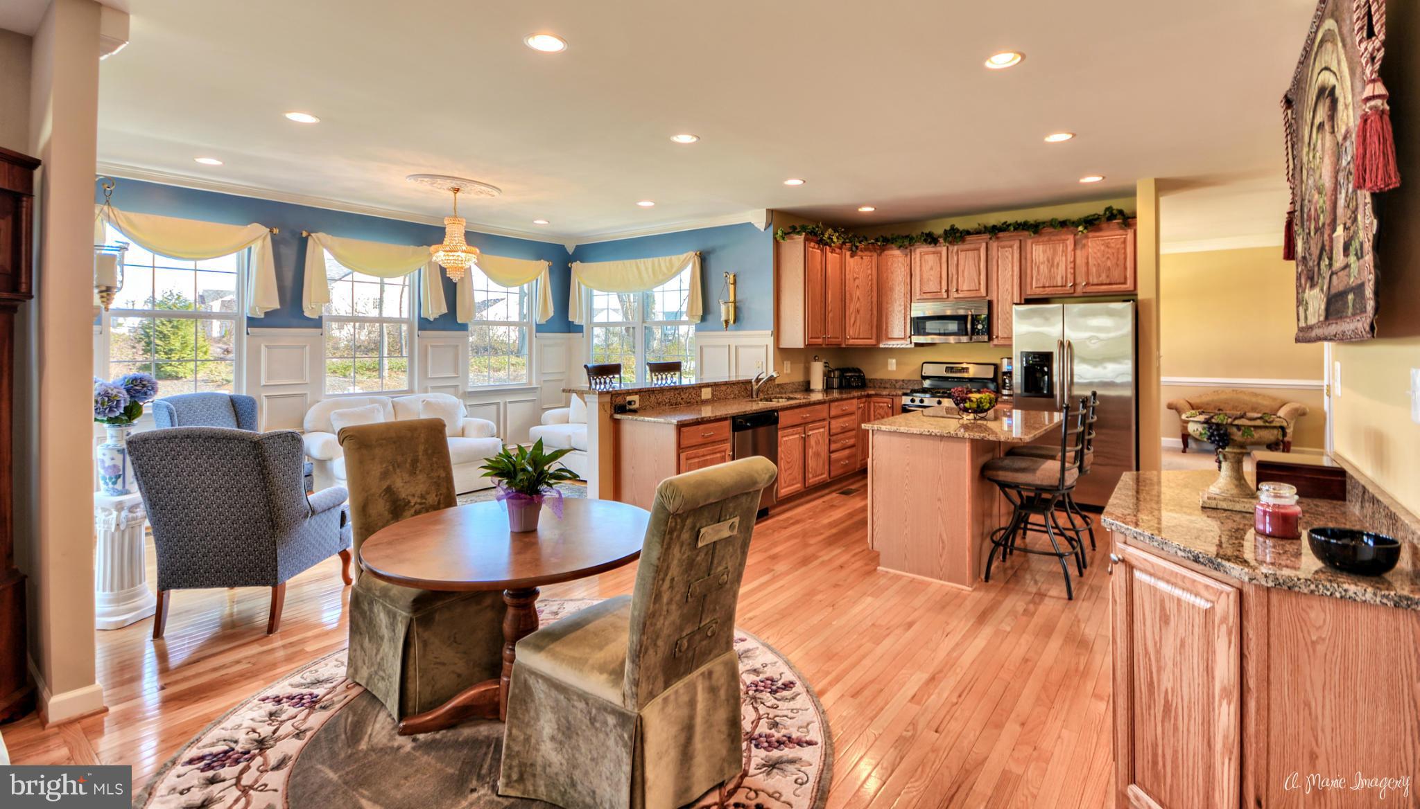 1719 Canal Clipper Court Point of Rocks, MD 21777 - Photo 9 of 30 a dining room with stainless steel appliances kitchen island granite countertop a table chairs and a living room view