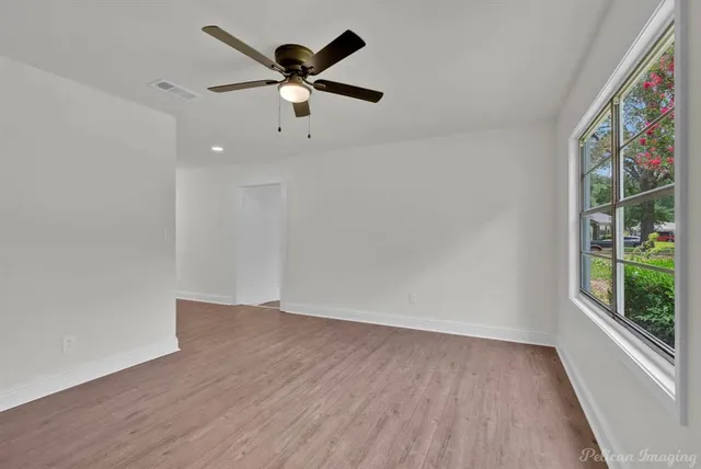 wooden floor in an empty room with a window