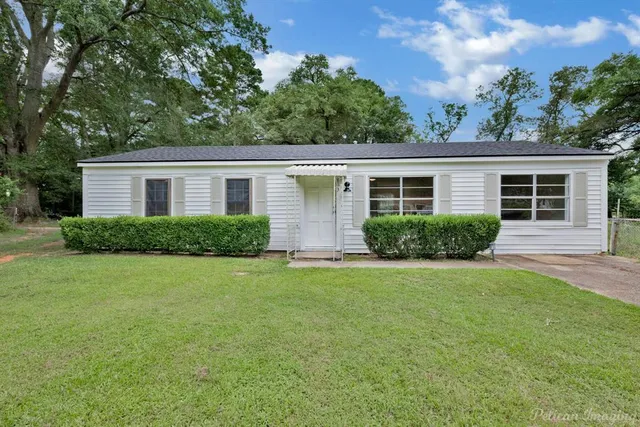 front view of the house and a yard