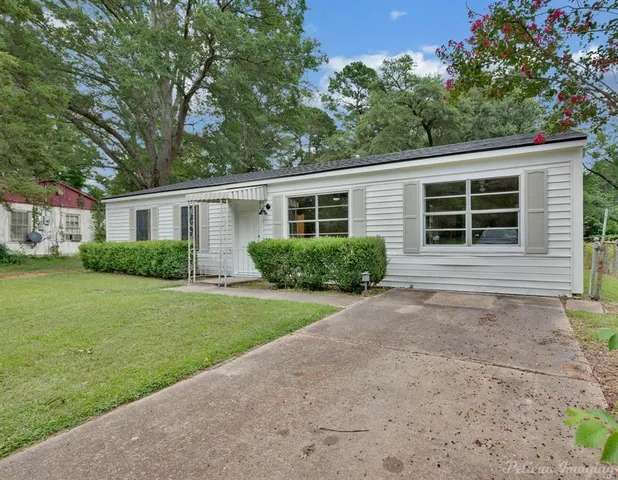 a house with a tree in front of it