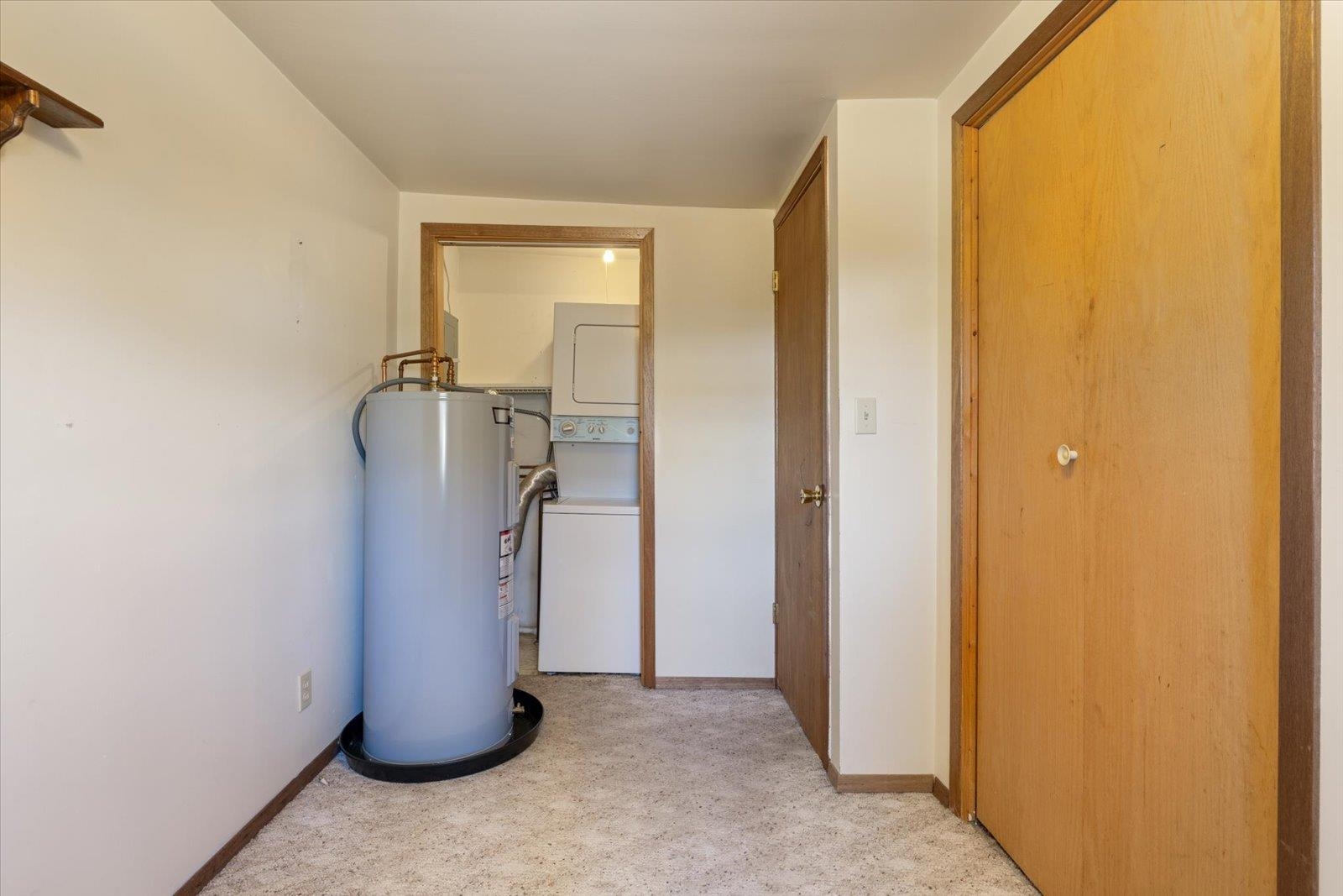 2120 Kelly Avenue Cloquet, MN 55720 - Photo 31 of 38 Corridor featuring water heater and estacked washer and dryer