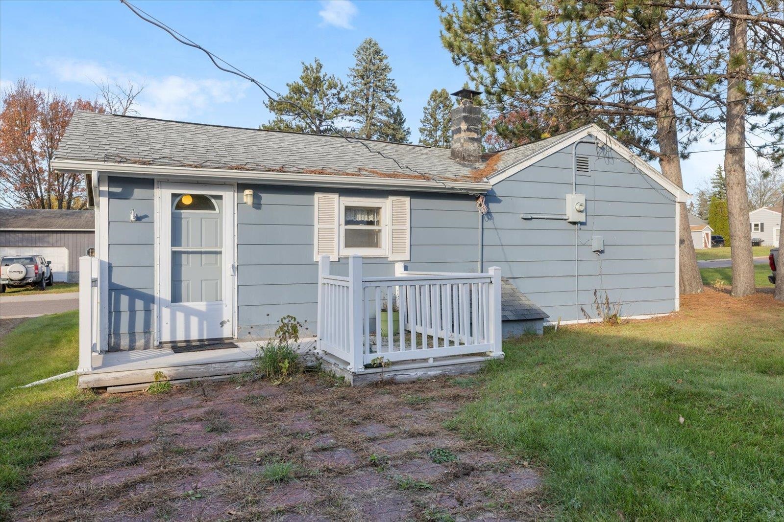 2120 Kelly Avenue Cloquet, MN 55720 - Photo 35 of 38 Back of house with a lawn, a chimney, a shingled roof, and a deck
