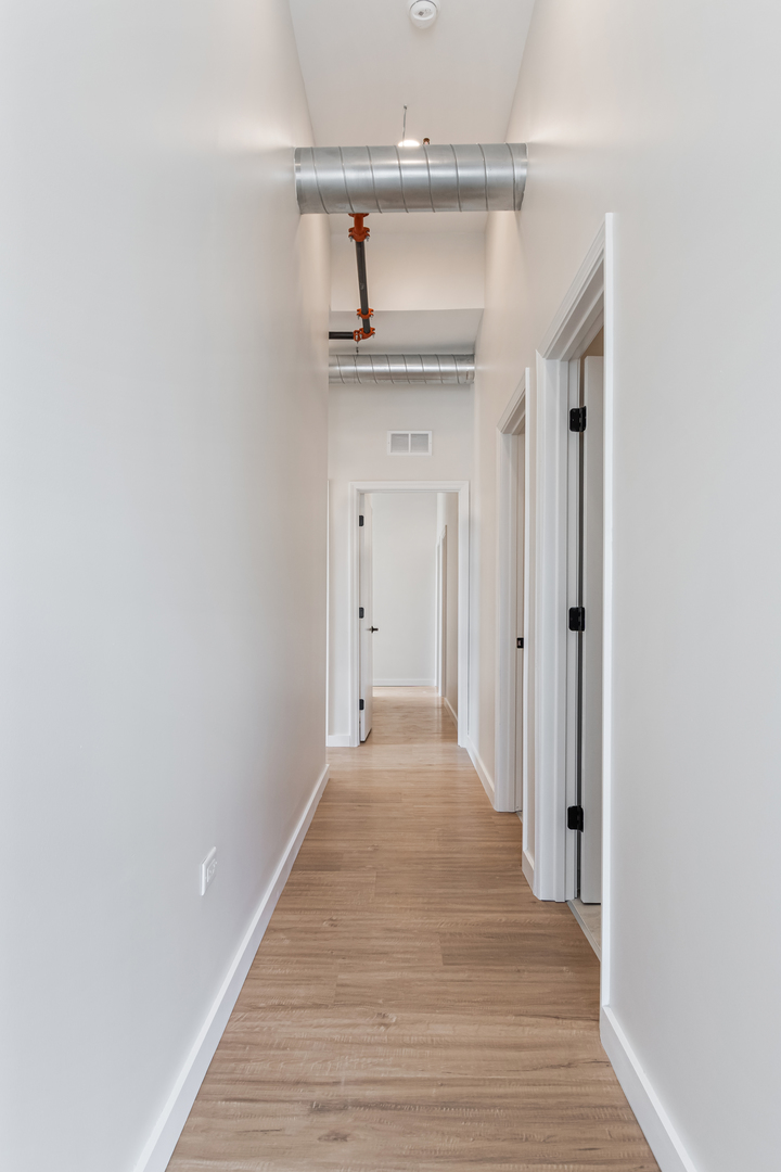 805 North Milwaukee Avenue, Unit 2S Chicago, IL 60642 - Photo 12 of 29 a view of a hallway with wooden floor