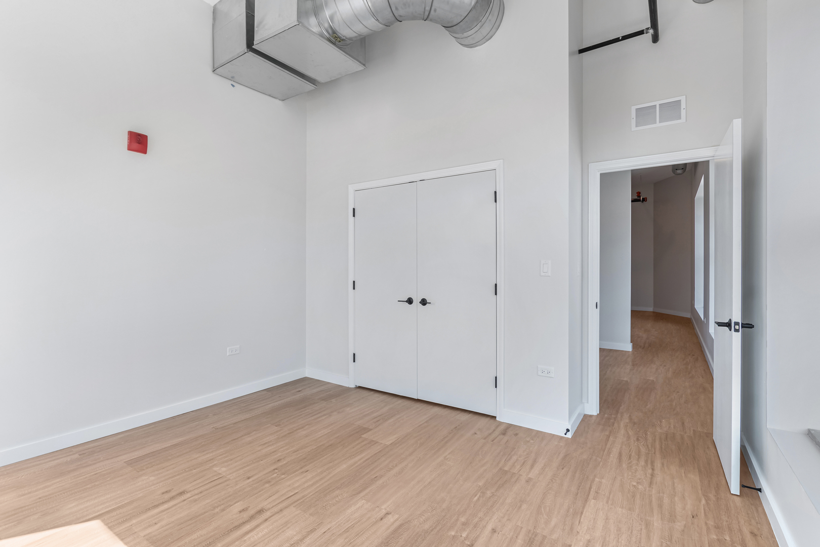 805 North Milwaukee Avenue, Unit 2S Chicago, IL 60642 - Photo 14 of 29 a view of a room with wooden floor and white walls