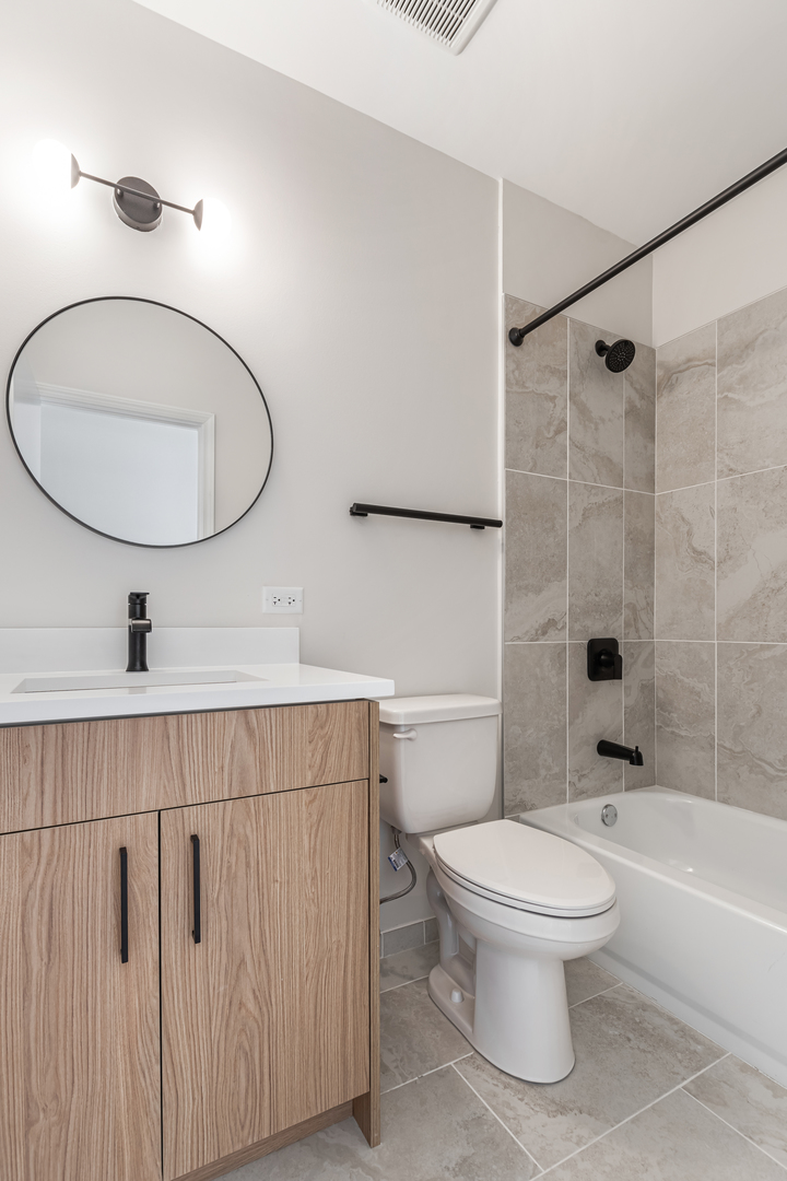 805 North Milwaukee Avenue, Unit 2S Chicago, IL 60642 - Photo 16 of 29 a bathroom with a toilet sink and shower