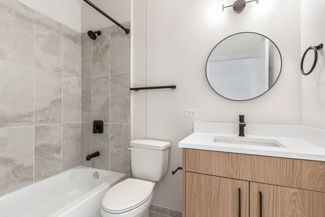 a bathroom with a toilet a sink and mirror