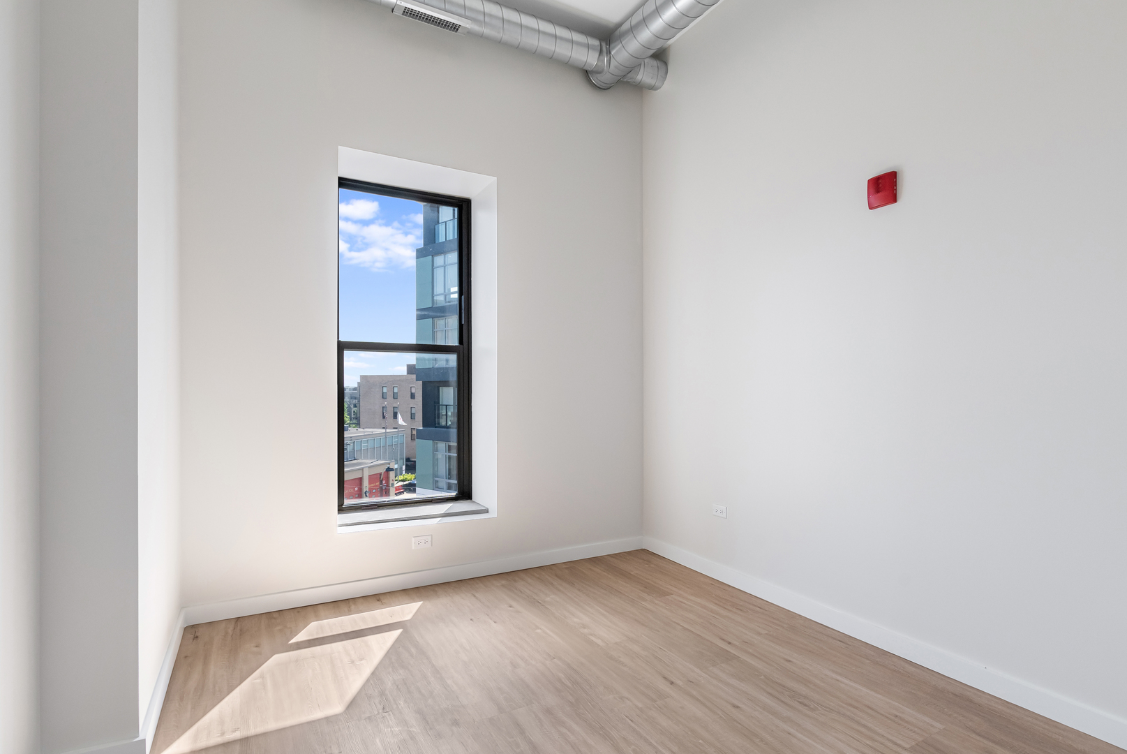 805 North Milwaukee Avenue, Unit 2S Chicago, IL 60642 - Photo 20 of 29 an empty room with wooden floor and windows