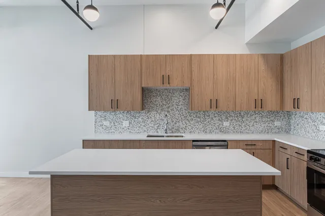 a kitchen with stainless steel appliances granite countertop a sink stove and microwave