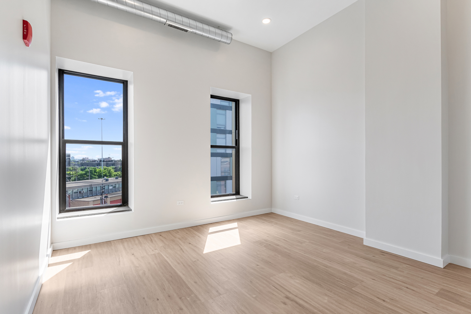 805 North Milwaukee Avenue, Unit 2S Chicago, IL 60642 - Photo 21 of 29 an empty room with wooden floor and windows