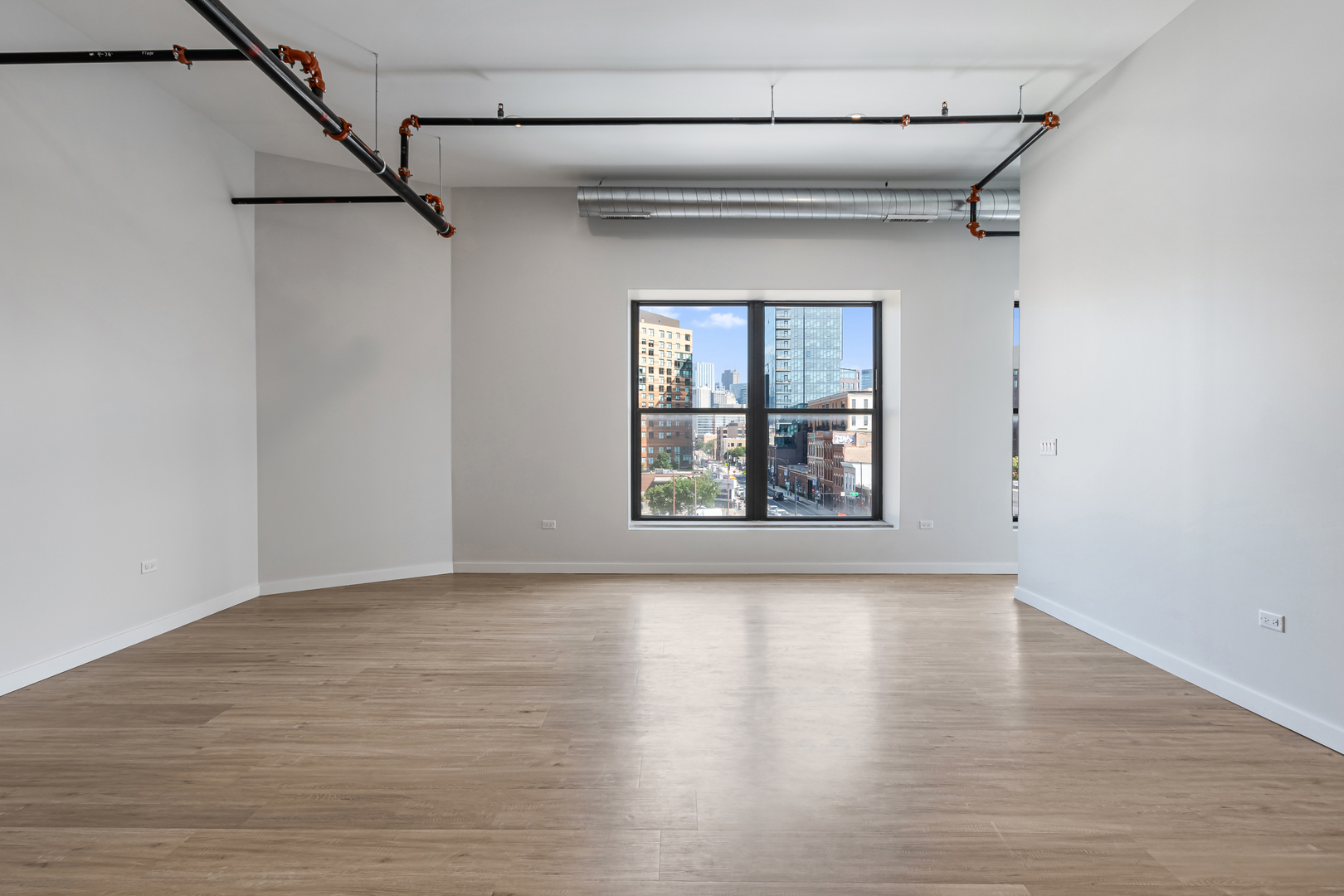 805 North Milwaukee Avenue, Unit 2S Chicago, IL 60642 - Photo 9 of 29 a view of an empty room with a window and wooden floor