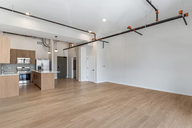 a view of a room with wooden floor and white walls