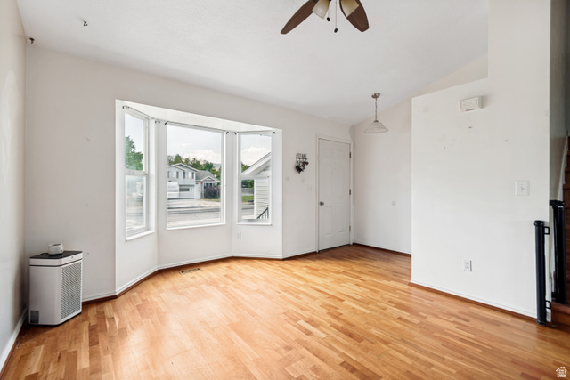 843 Deer Flat Road Tooele, UT 84074 - Photo 4 of 27 Bright interior space featuring a bay window with multiple panes, wood-finish flooring, and white painted walls