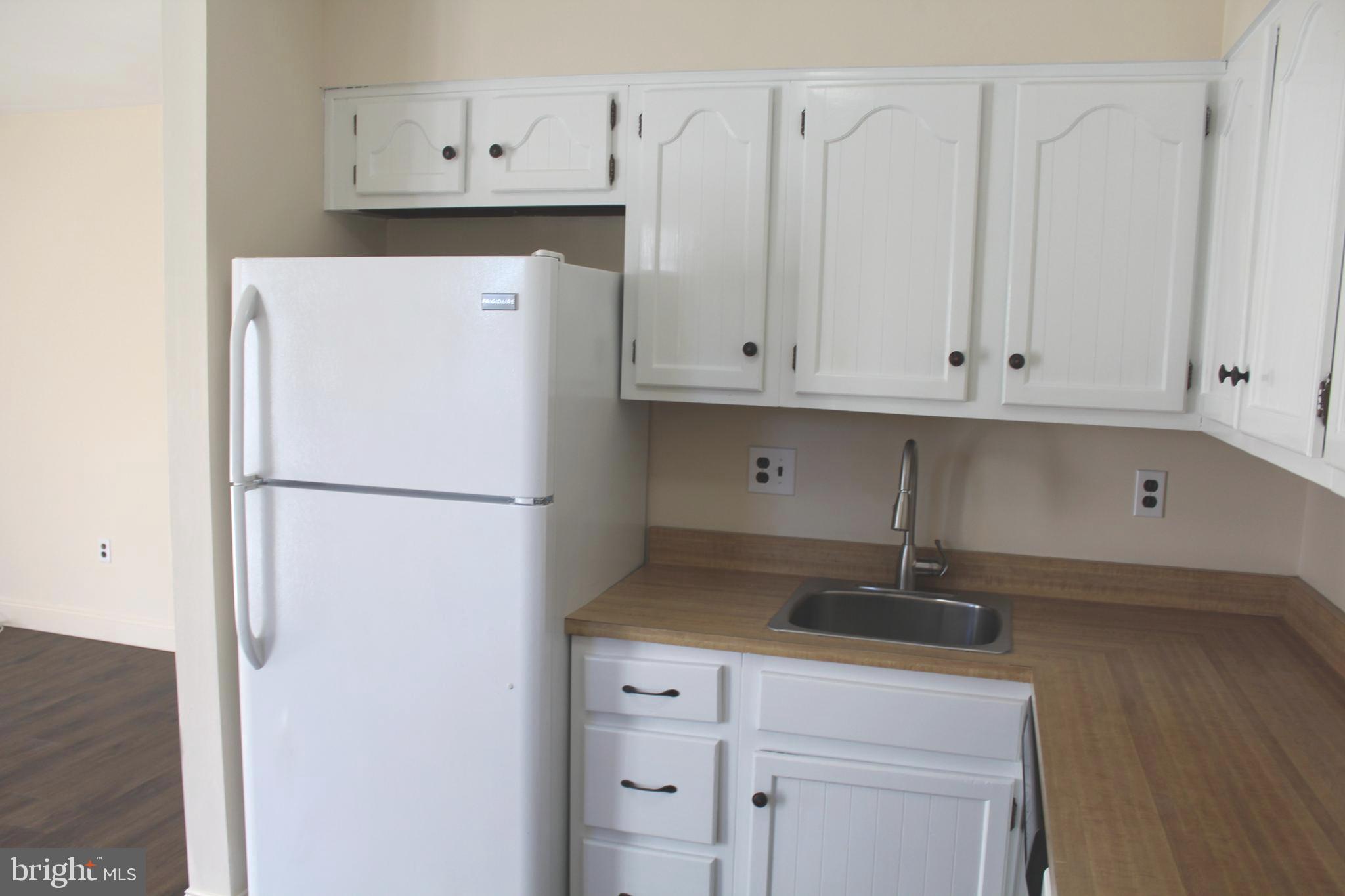 214 Lexington Road Schwenksville, PA 19473 - Photo 12 of 29 a kitchen with refrigerator and cabinets