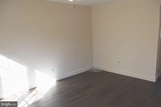a view of an empty room and wooden floor
