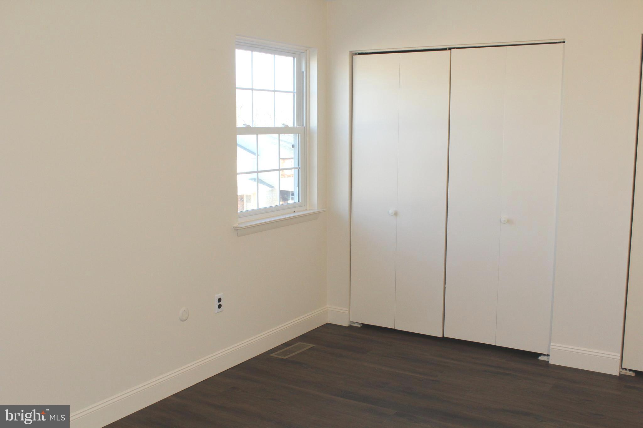 214 Lexington Road Schwenksville, PA 19473 - Photo 20 of 29 a view of an empty room with wooden floor and a window