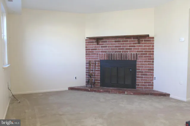 a view of an empty room and fire place
