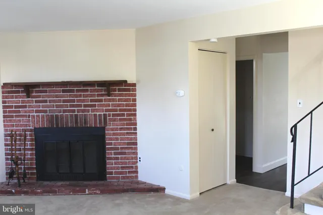 a an empty room with a fireplace