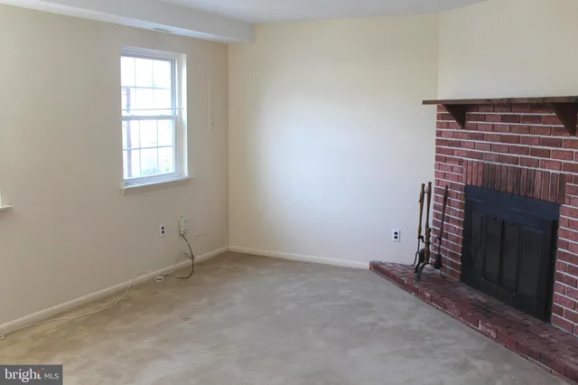 a view of an empty room with a fireplace