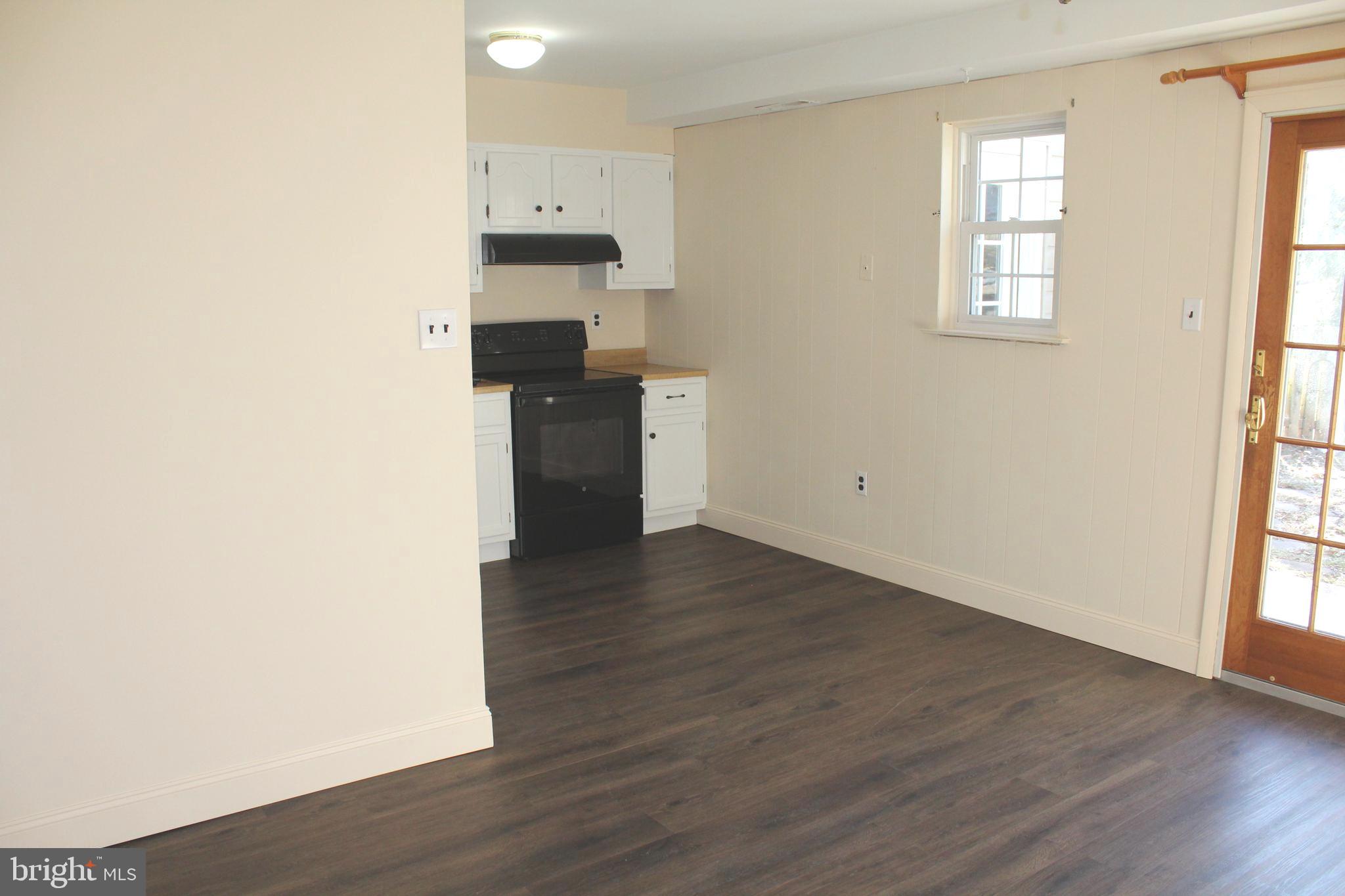 214 Lexington Road Schwenksville, PA 19473 - Photo 10 of 29 an empty room with wooden floor and a window
