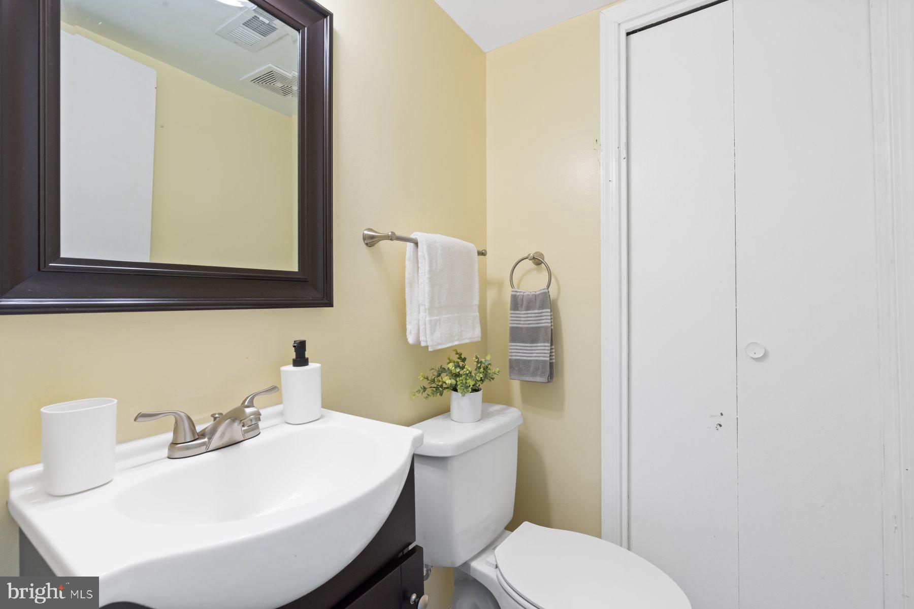 1719 Addison Road South District Heights, MD 20747 - Photo 4 of 22 a bathroom with a sink a toilet and mirror
