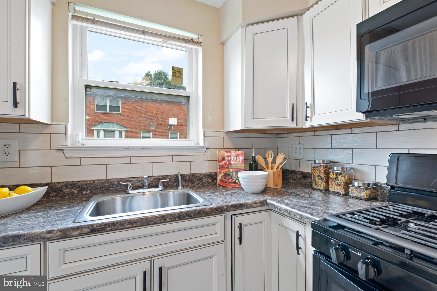 1719 Addison Road South District Heights, MD 20747 - Photo 8 of 22 a kitchen with granite countertop a sink stainless steel appliances and cabinets