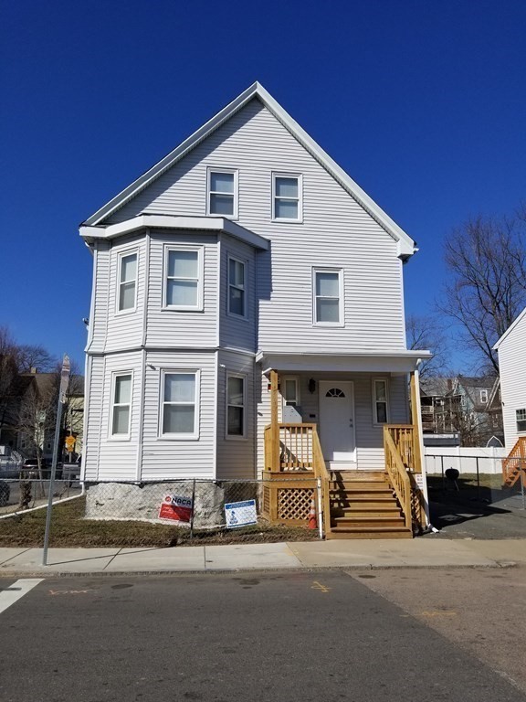 593 Park Street, Unit 3 Boston, MA 02124 - Photo 1 of 29 a front view of a house with garage