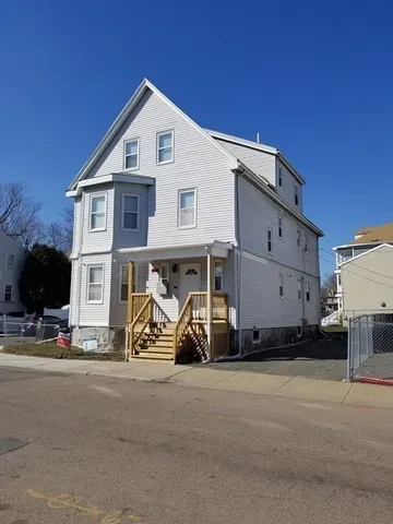 a view of a car park in front of house