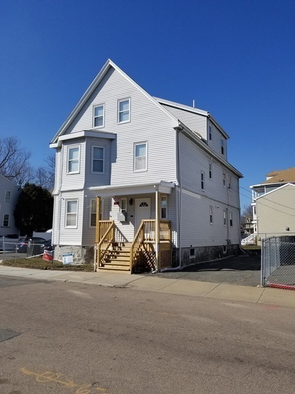 593 Park Street, Unit 3 Boston, MA 02124 - Photo 2 of 29 a view of a car park in front of house