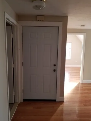 a view of a hallway with wooden floor
