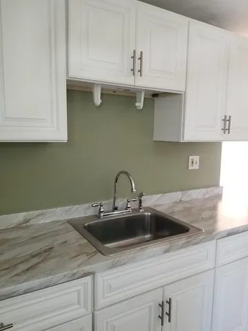 a kitchen with kitchen island a sink dishwasher and cabinets