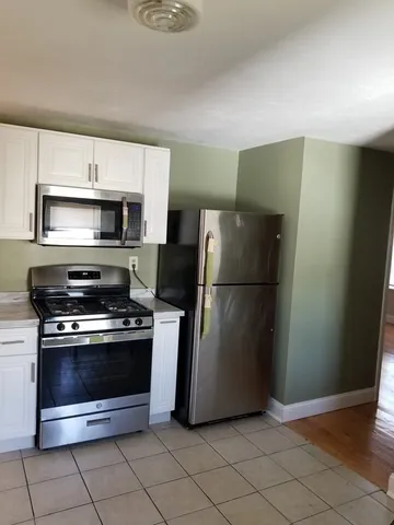 a kitchen with a refrigerator and a stove