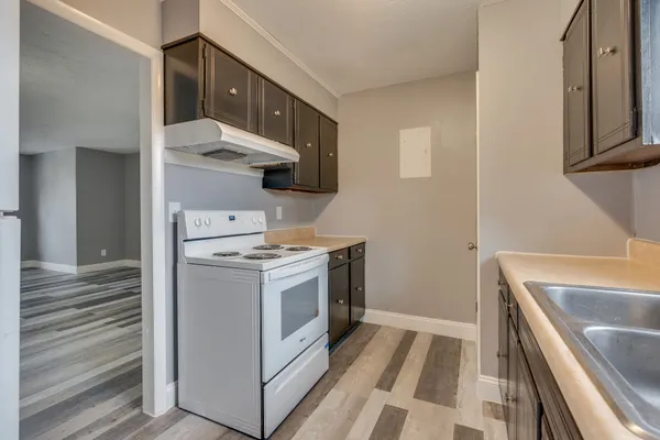 a kitchen with stove and cabinets