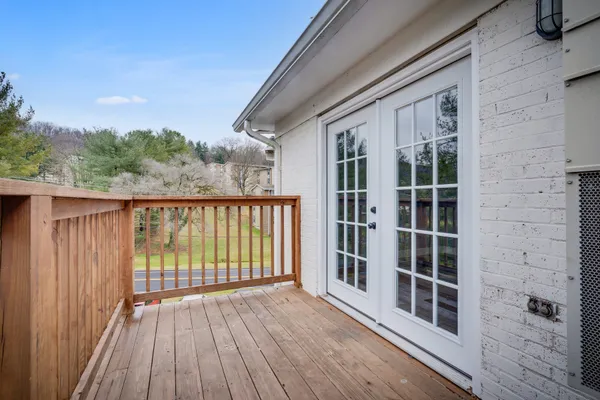 a balcony with wooden floor and fence