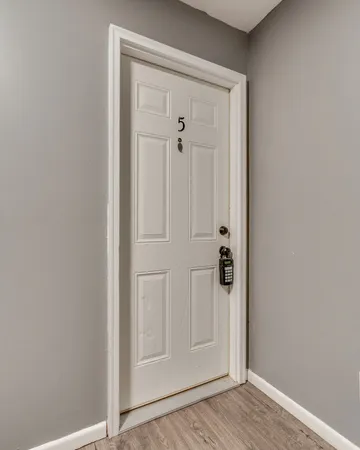 a view of a hallway with wooden floor