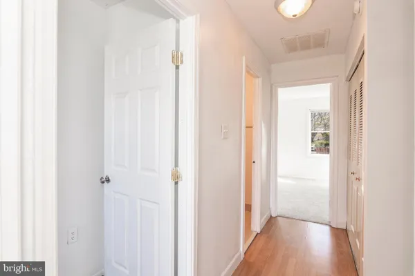 a view of a hallway with wooden floor