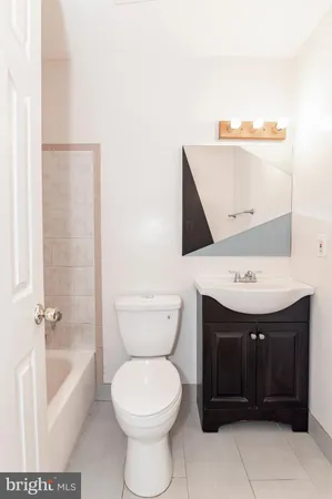 a bathroom with a toilet a sink and bathtub