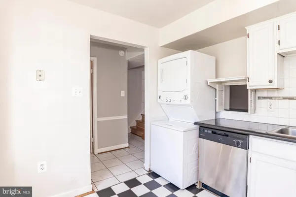 a kitchen with stainless steel appliances a sink and a refrigerator