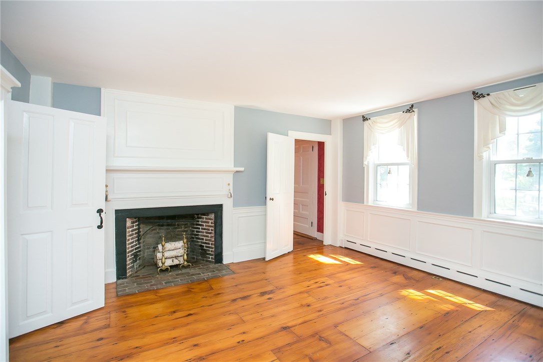 697 Middle Road Portsmouth, RI 02871 - Photo 8 of 38 The Formal Living Room opens to the front entrance. Custom molding and mill work is featured on the walls and above the fireplace.